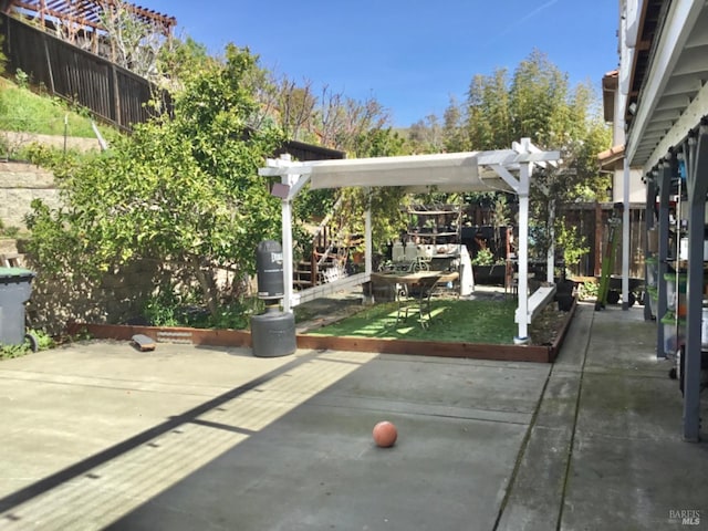 view of patio featuring a pergola and fence