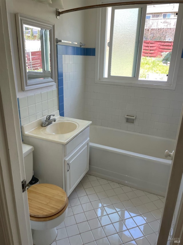 bathroom featuring tile patterned flooring, backsplash, tile walls, toilet, and vanity