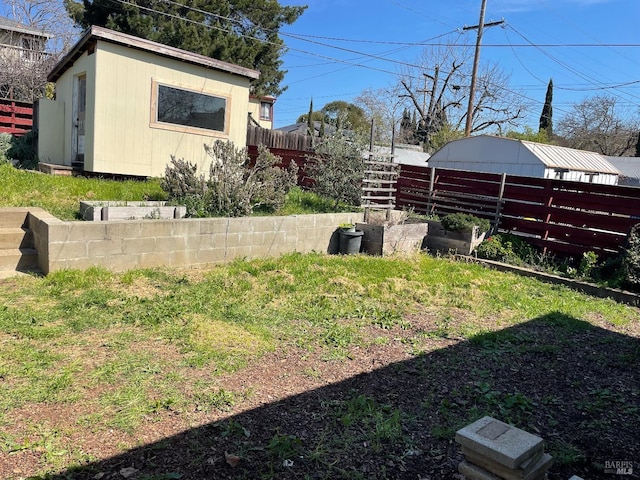 view of yard featuring an outdoor structure and fence