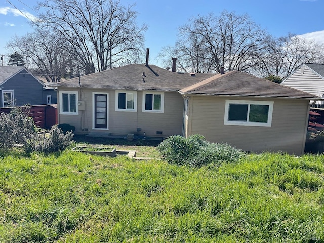 back of house featuring crawl space and a shingled roof