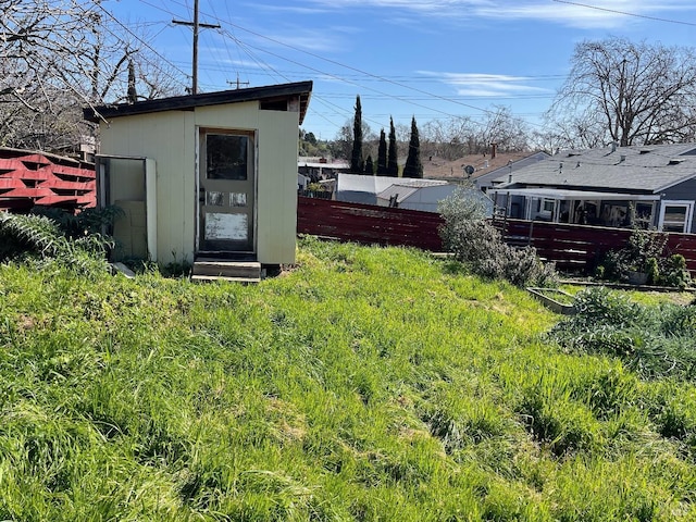 view of yard featuring an outbuilding and fence