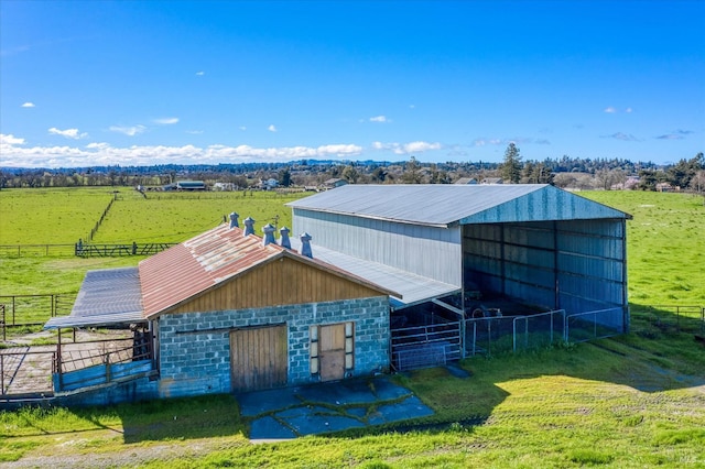 view of outdoor structure with an exterior structure, a rural view, and an outdoor structure