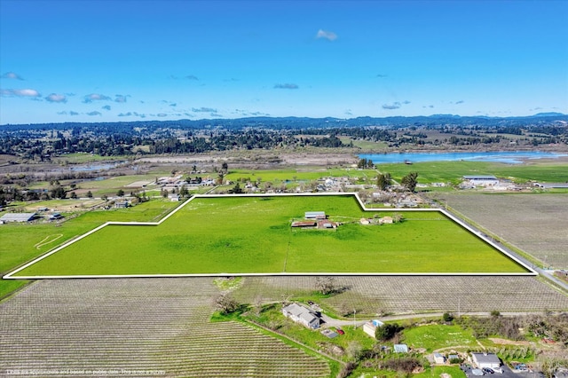 birds eye view of property featuring a water view and a rural view