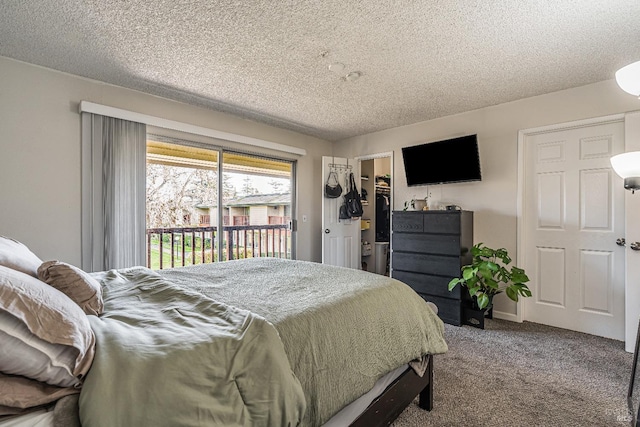 bedroom with a walk in closet, carpet, a closet, a textured ceiling, and access to outside