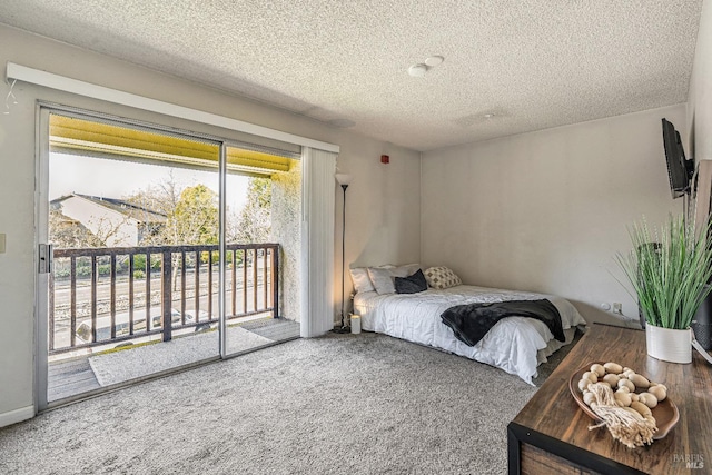 bedroom with access to outside, carpet, and a textured ceiling