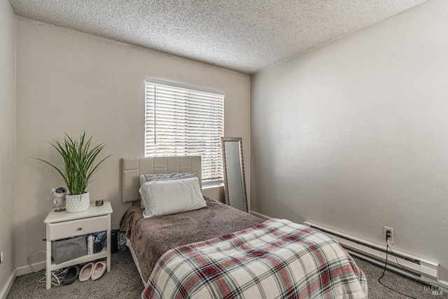 bedroom featuring baseboards, carpet floors, baseboard heating, and a textured ceiling