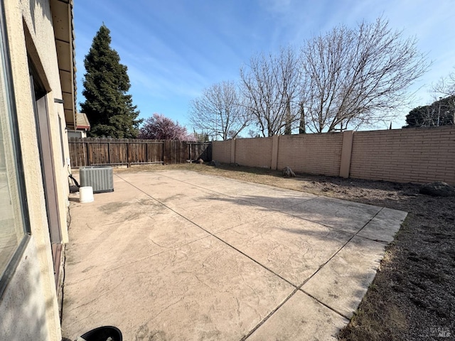 view of patio / terrace with cooling unit and a fenced backyard