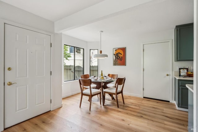 dining room featuring light wood-style flooring and baseboards