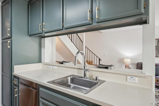 kitchen featuring a sink, blue cabinetry, dishwasher, and light countertops