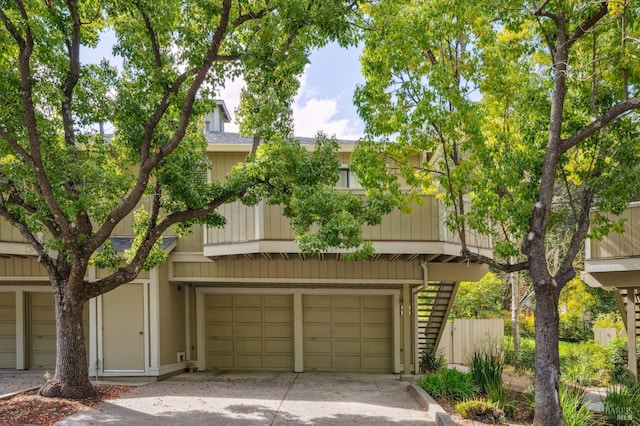 townhome / multi-family property with concrete driveway and a garage