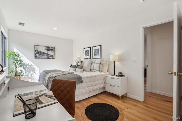 bedroom with light wood-type flooring, visible vents, baseboards, and recessed lighting