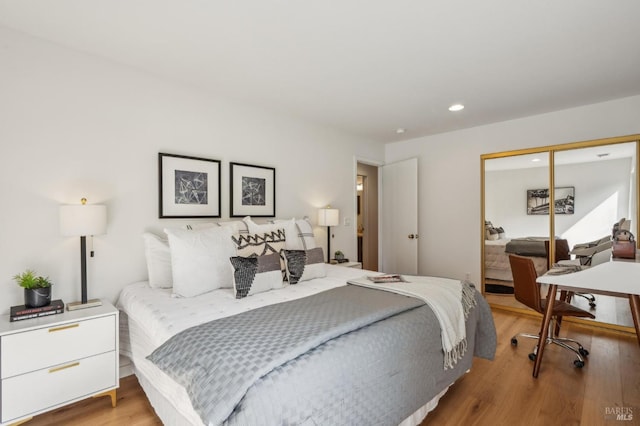 bedroom featuring recessed lighting, a closet, and light wood finished floors