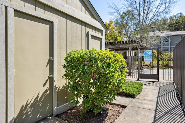 view of property exterior featuring fence and a gate