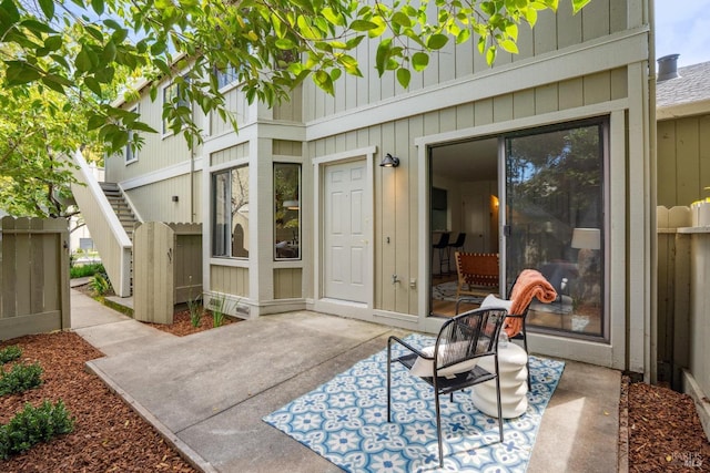 view of patio / terrace featuring stairs and fence