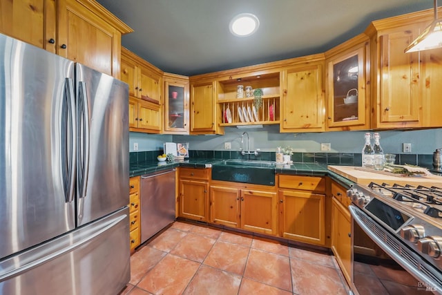 kitchen with open shelves, light tile patterned flooring, a sink, stainless steel appliances, and glass insert cabinets