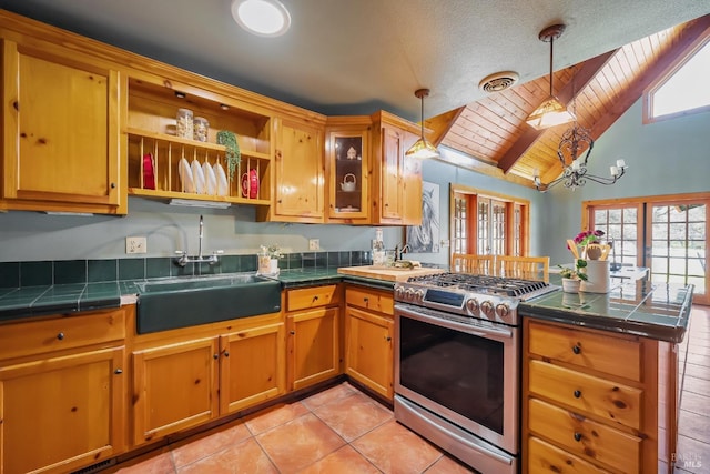 kitchen with visible vents, stainless steel gas stove, plenty of natural light, and a peninsula