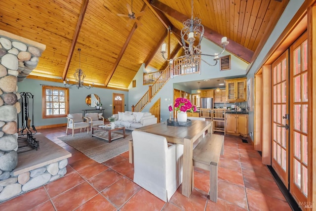 kitchen with beam ceiling, ceiling fan with notable chandelier, wooden ceiling, and high vaulted ceiling