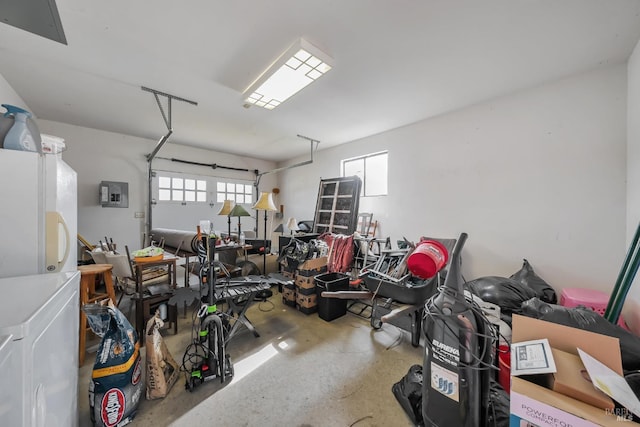 garage with refrigerator, electric panel, and freestanding refrigerator