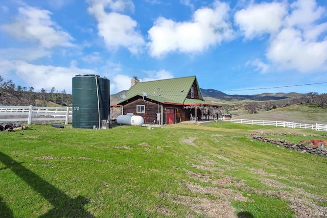 view of yard featuring a rural view and fence