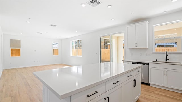 4040 Molten Creek Way, Roseville, CA 95747 - kitchen featuring a sink, stainless steel dishwasher, light wood finished floors, decorative backsplash, and light countertops