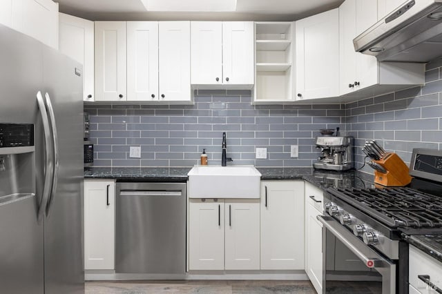 kitchen featuring open shelves, a sink, stainless steel appliances, under cabinet range hood, and backsplash