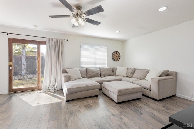 living room with recessed lighting, wood finished floors, and baseboards