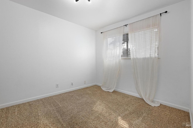 empty room featuring baseboards and carpet floors