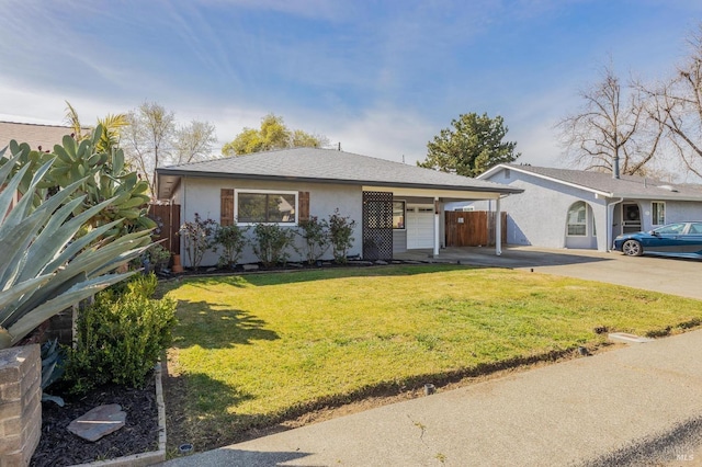 ranch-style house with stucco siding, fence, concrete driveway, an attached garage, and a front yard