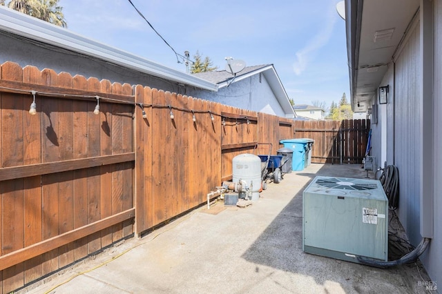 view of patio with cooling unit and fence