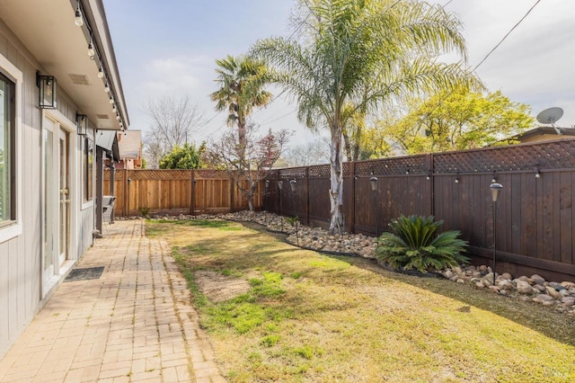 view of yard featuring a patio and a fenced backyard