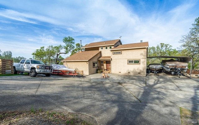 view of front of property with crawl space, roof with shingles, and stucco siding