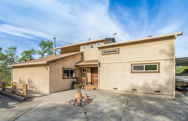 back of house featuring crawl space, stucco siding, a shingled roof, and a patio