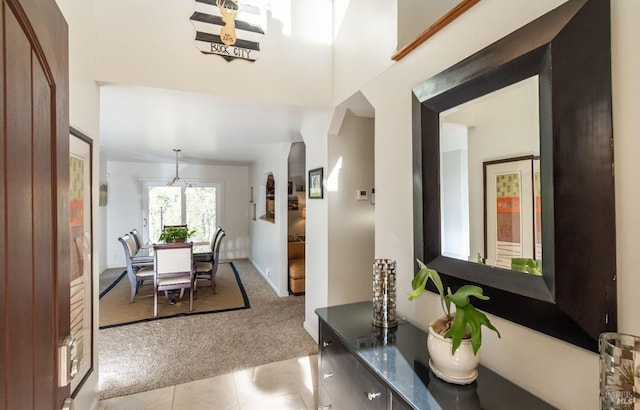 dining room featuring light tile patterned floors and light colored carpet