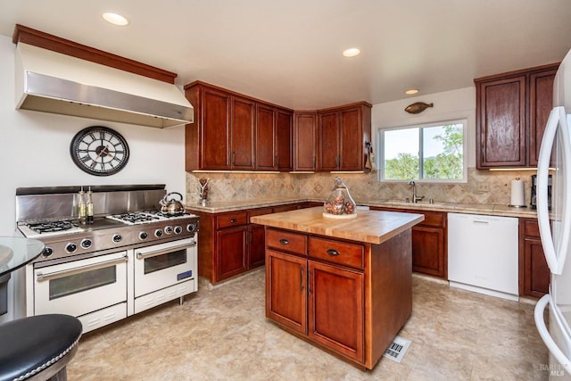 kitchen featuring visible vents, backsplash, extractor fan, white appliances, and a sink