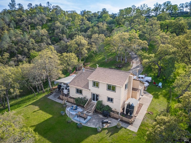 birds eye view of property with a view of trees