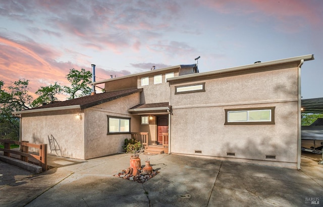 rear view of property featuring crawl space, a patio area, stucco siding, and a shingled roof