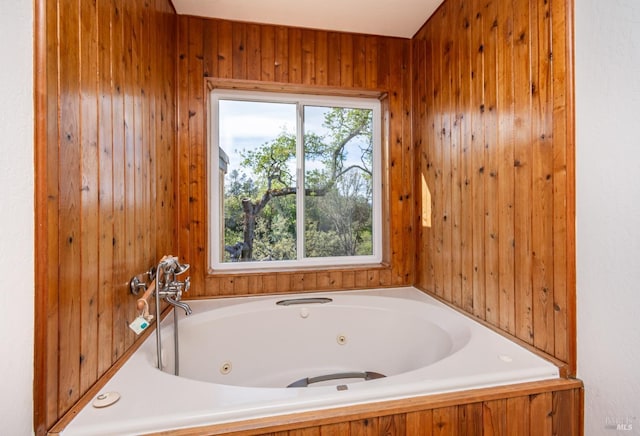 full bathroom featuring wooden walls and a whirlpool tub