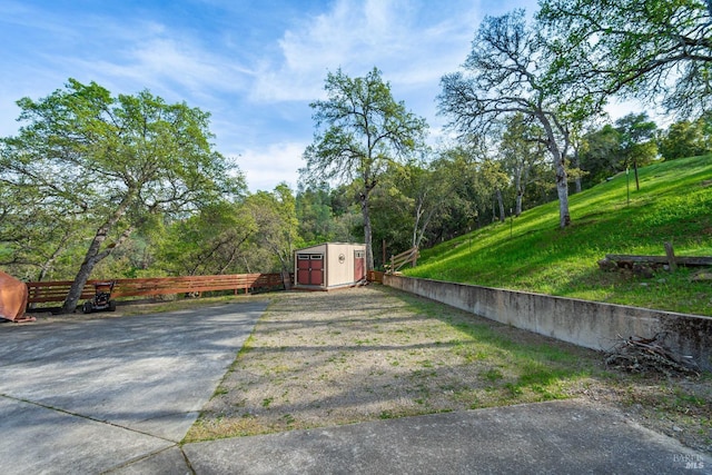 exterior space featuring a shed, an outdoor structure, and fence