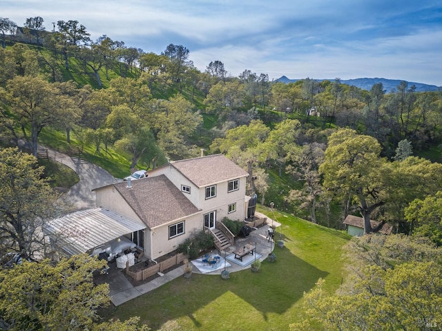 drone / aerial view featuring a wooded view