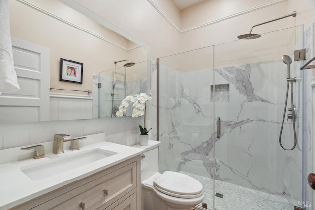 full bathroom with a marble finish shower, tasteful backsplash, toilet, and vanity