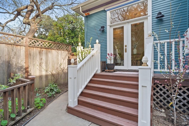 doorway to property with french doors and fence