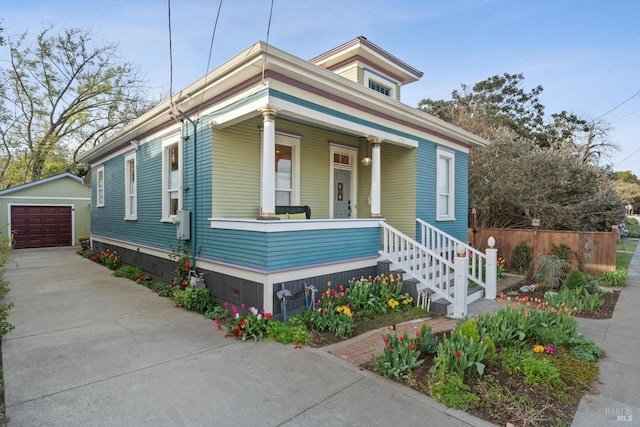 1133 Eggleston St, Napa, CA 94559 - view of front of home with concrete driveway, an outdoor structure, a detached garage, and covered porch