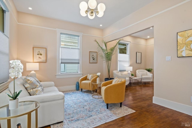 living room featuring recessed lighting, wood finished floors, baseboards, and a chandelier