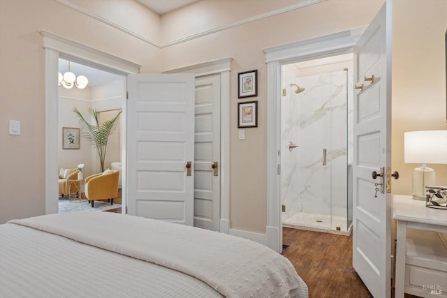 bedroom with dark wood finished floors and ensuite bathroom