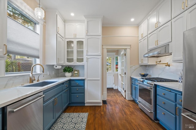 kitchen featuring blue cabinets, under cabinet range hood, a sink, stainless steel appliances, and white cabinets