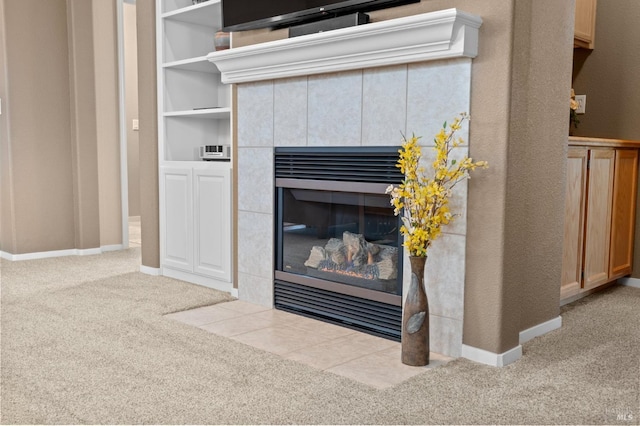 interior details featuring carpet flooring, a tile fireplace, and baseboards