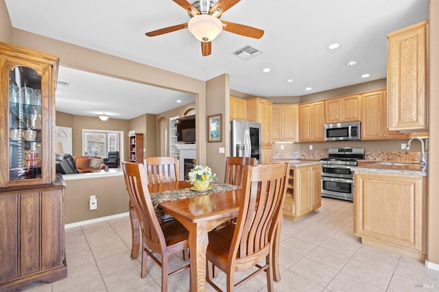 dining room with visible vents, baseboards, recessed lighting, a fireplace, and light tile patterned flooring