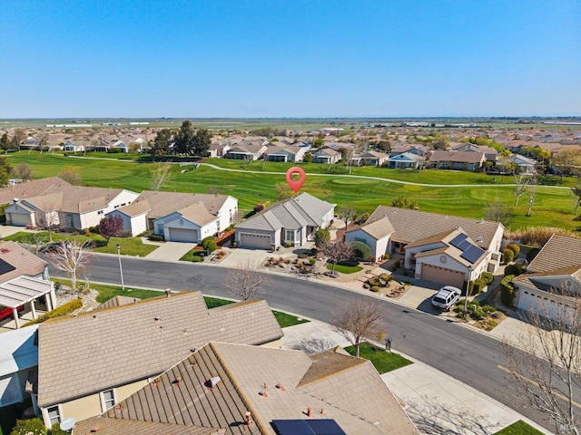 bird's eye view with view of golf course and a residential view