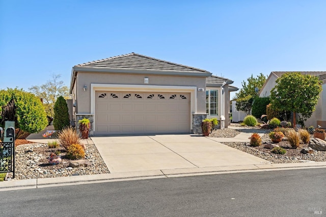 ranch-style house featuring stucco siding, stone siding, an attached garage, and driveway