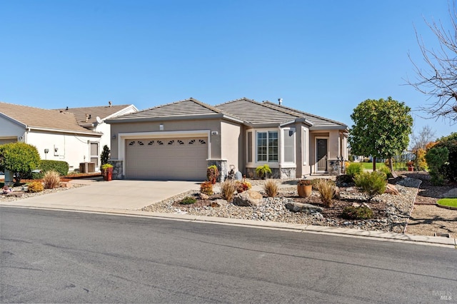 view of front facade featuring stucco siding, concrete driveway, an attached garage, and a tiled roof